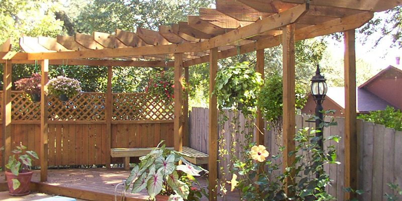 A pergola on top of a fence