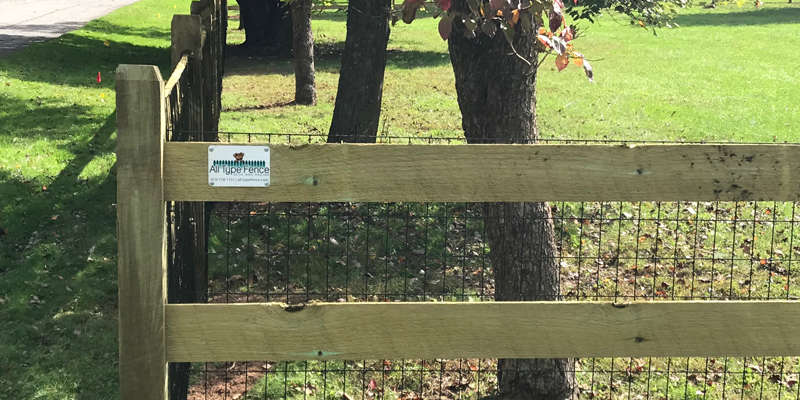 A wooden fence with an ATF sign on it