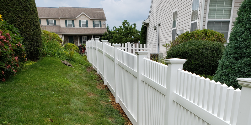 A white fence between two houses